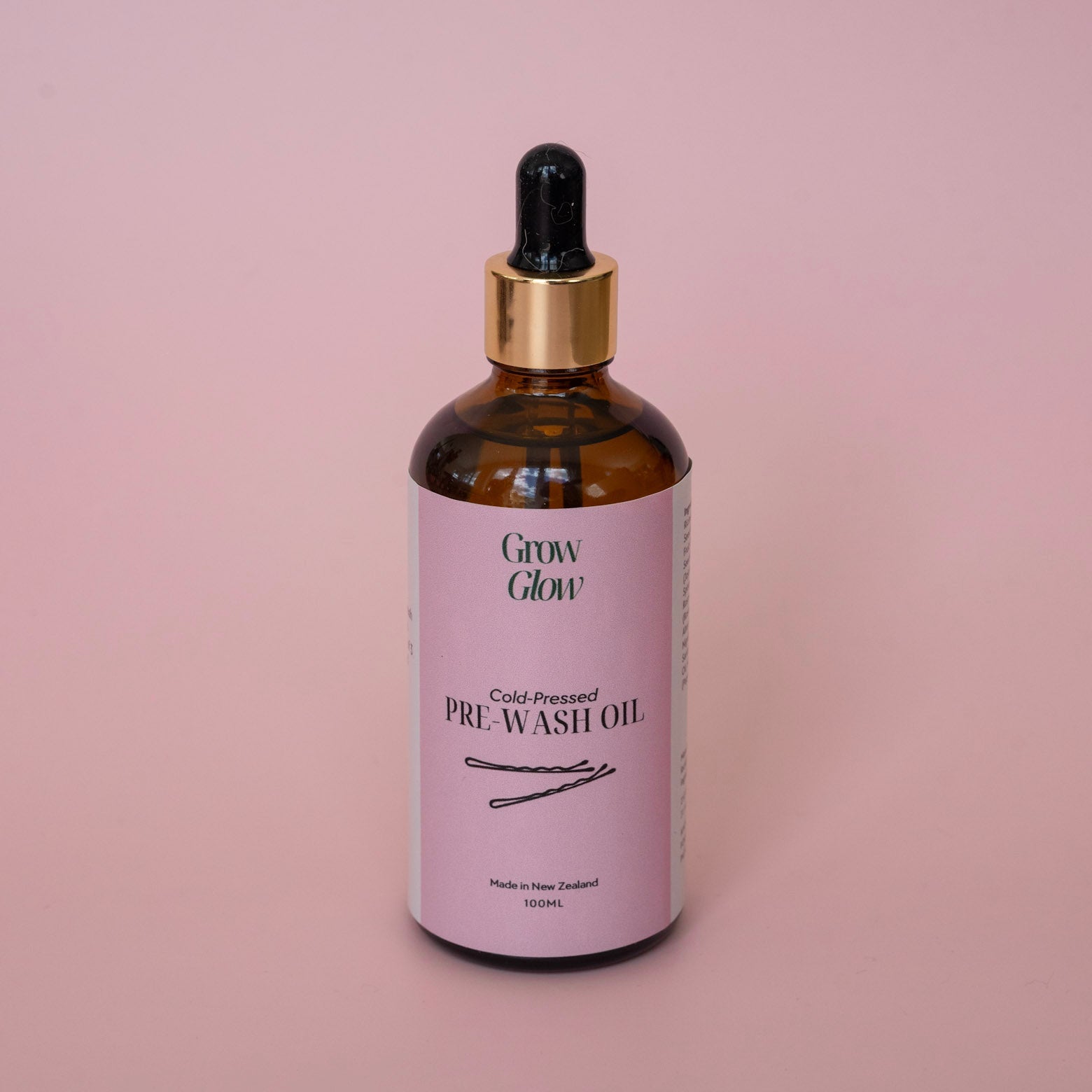 Bottle of natural Grow Glow Hair and Scalp Oil. Our Scalp oil contains no harsh ingredients.